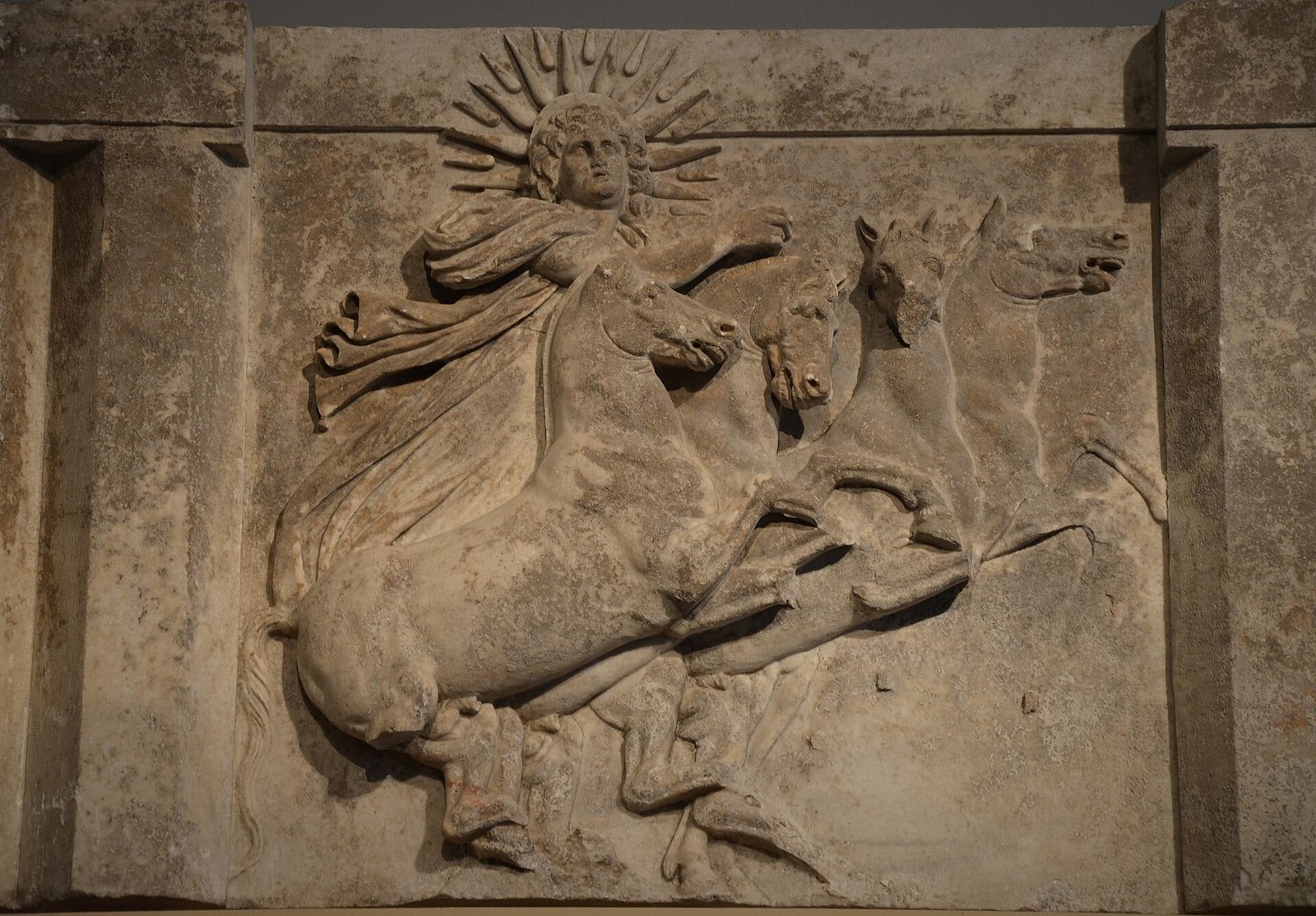 Marble metope from the temple of Athena at Troy, about 300 to 280 BC. Helios, the Sun, with rays around his head, drives his four horses up into the sky.