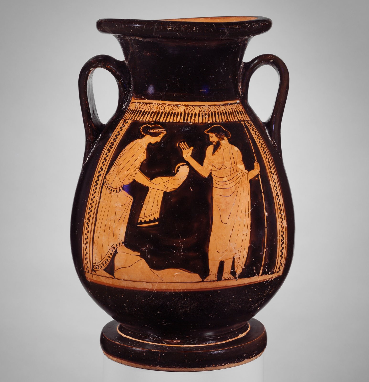 Athenian red-figure jar, about 460 to 450 BC, painted by the Nausicaa Painter. Rhea hands her husband Kronos a stone wrapped like a baby, and he holds out his hand to take it, believing it is his newborn son Zeus.