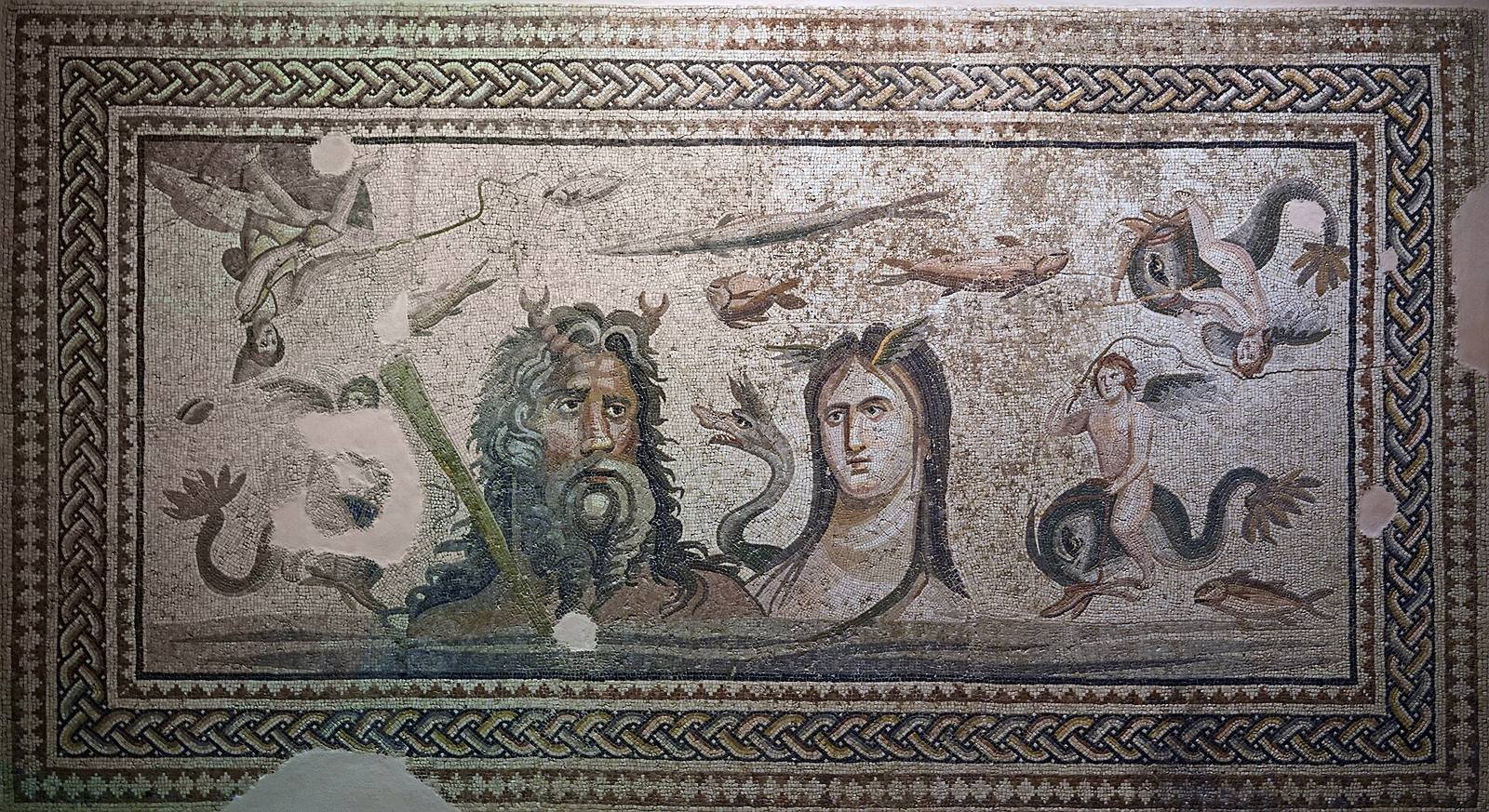 Roman floor mosaic from Zeugma on the Euphrates, 2nd to 3rd century AD. Tethys, with small wings on her brow, rises from the sea beside her husband Oceanus, who has crab claws on his head; a sea dragon coils between them, and winged boys ride dolphins at the sides.