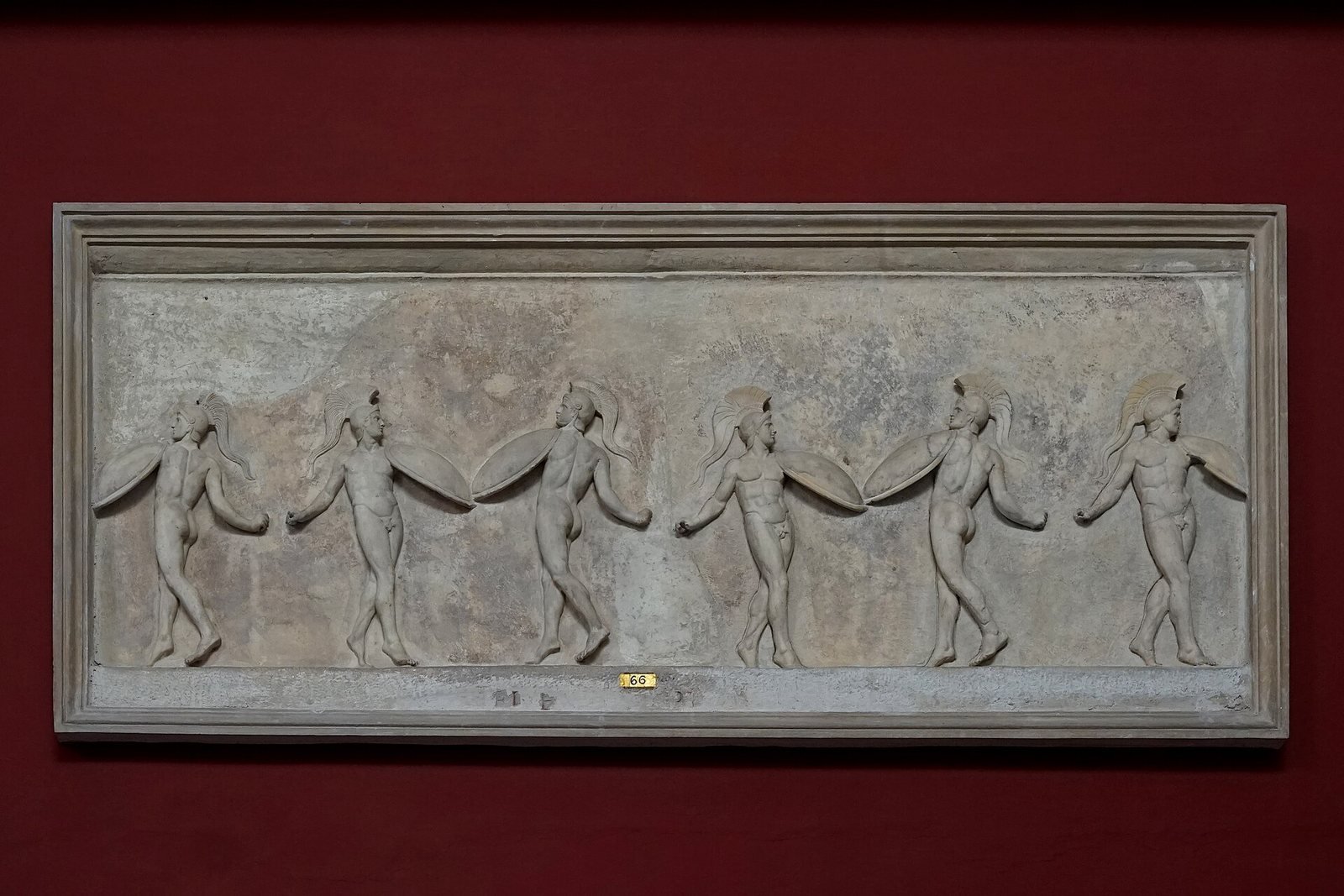 No ancient image of Korybas has been identified. This Roman marble relief of the 1st century BC, copied from an Athenian work, is traditionally called the Dance of the Korybantes: six young warriors in crested helmets dance in a line with their shields.