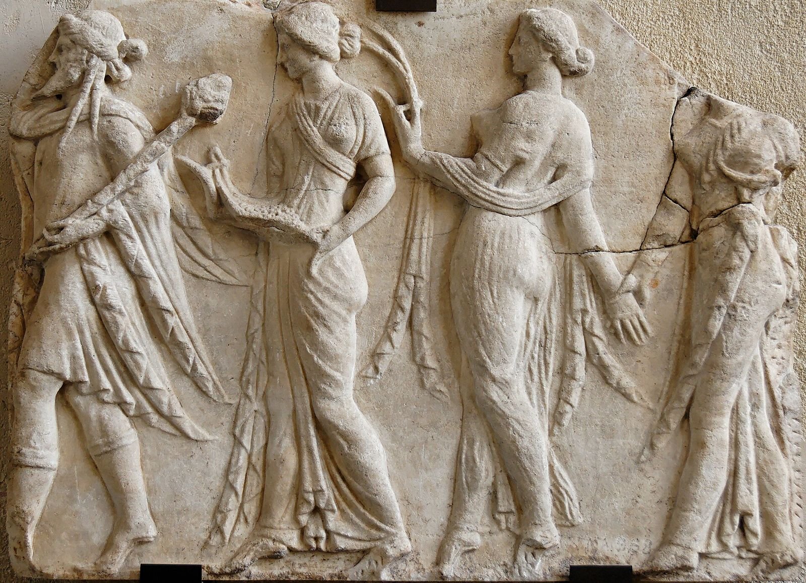 Roman marble relief, 1st century AD, copied from a Greek design of the Hellenistic period. Bearded Dionysus leads the Seasons, three young women who follow him in a dance.