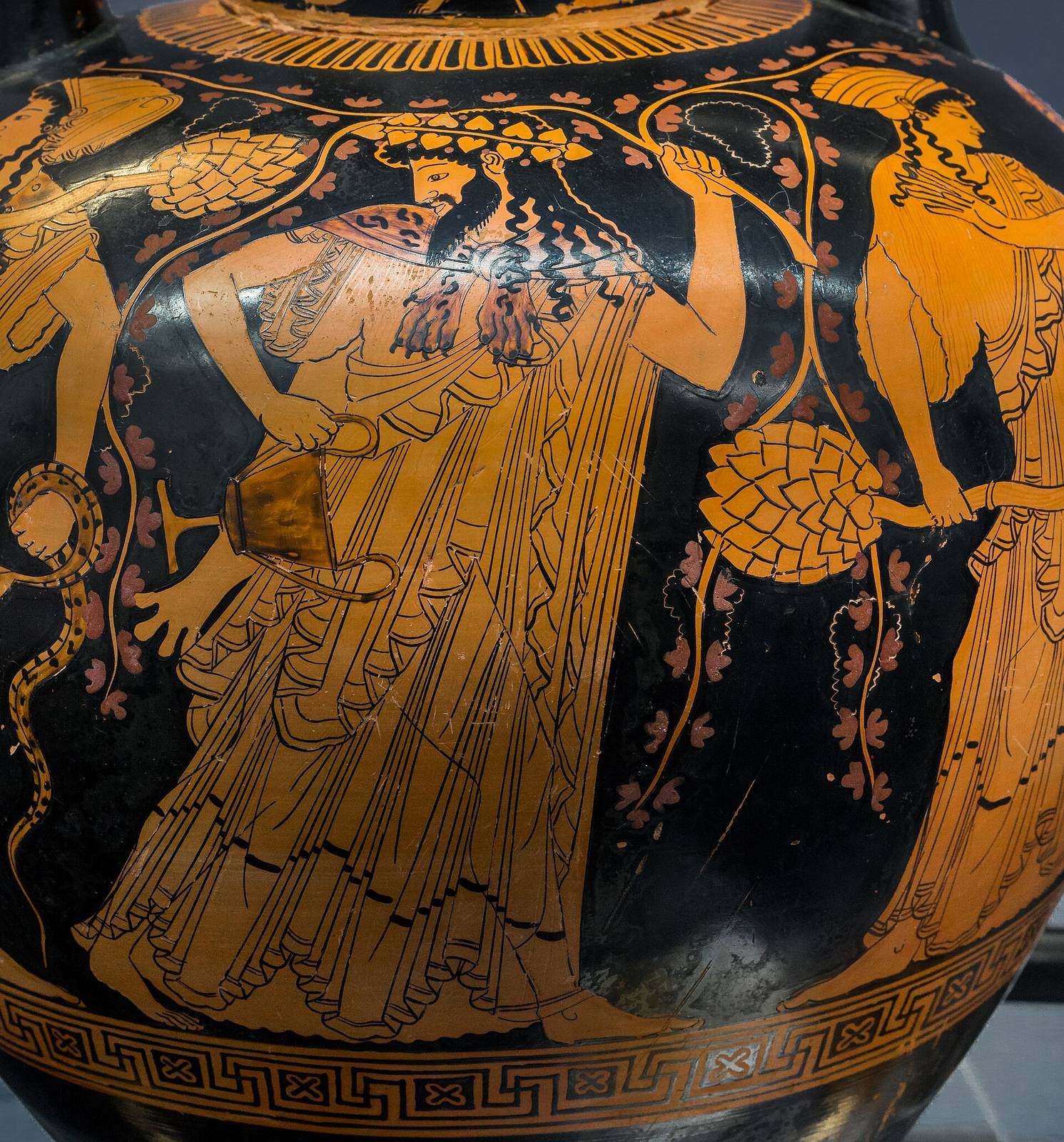 Athenian red-figure amphora, about 500 BC, attributed to the Kleophrades Painter. Dionysus, crowned with ivy, holds a wine cup and a vine between two of his Maenads, one with a snake and one with a thyrsus.