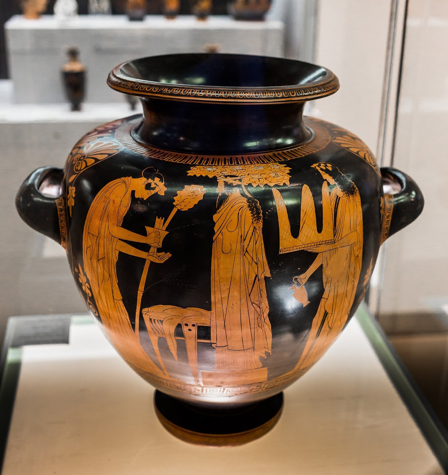 Athenian red-figure stamnos, about 440 BC, attributed to the Eupolis Painter. Women bring wine and cakes to an image of Dionysus made from a pillar, dressed in a robe and hung with a bearded mask.